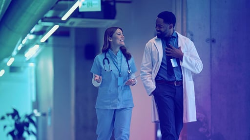 Doctor and nurse walking and talking in a corridor