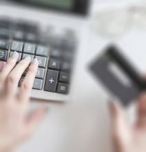 Hand on a calculator representing managing your finances